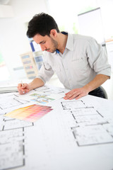 Architect in office drawing construction blueprint