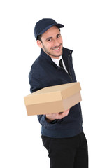 Smiling delivery man holding package towards camera