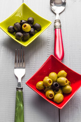 Colorful fruits olives bowls wooden table cutlery