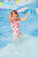 Fototapeta na wymiar Cute baby girl in the pool