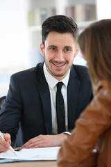Woman meeting financial adviser in office