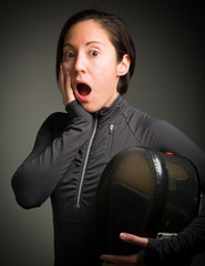Female fencer looking shock with hand on cheek