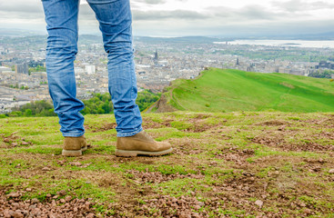 Focus on legs of a female model wearing skinny blue jeans and br