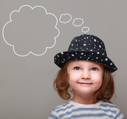 Dreaming kid girl in hat looking up on empty bubble above