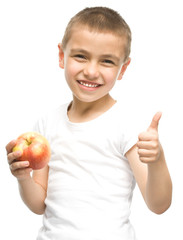 Portrait of a happy little boy with apples