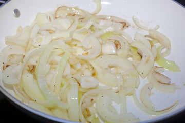 Cooking caramelized onions in a frying pan