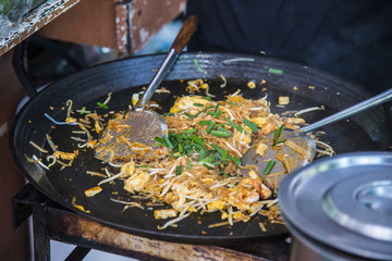 Cooking Stir-Fried Rice Noodle with Shrimp on iron pan