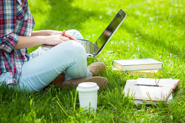 Working on laptop outdoors.