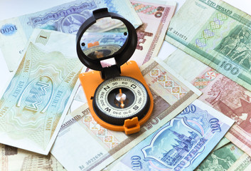 Banknotes and compass. Navigation in the world of Finance.