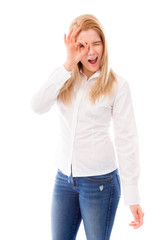 Young woman looking through finger's hole