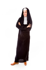 Young nun standing with her arms crossed