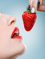 Seduction - Women's mouth eats strawberries