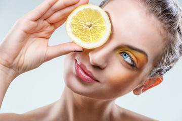  Beautiful woman with lemon and yellow makeup