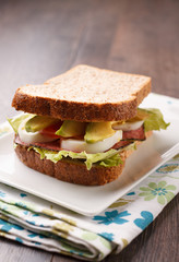 Healthy sandwich with eggs, avocado and vegetables