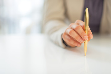 Closeup on business woman holding pen