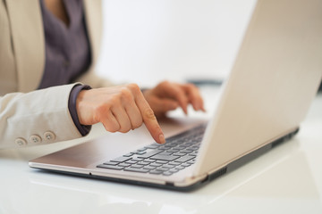 Closeup on business woman working on laptop