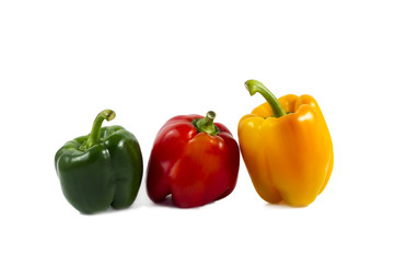 colored peppers over white background