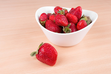strawberries in a bowl on the table