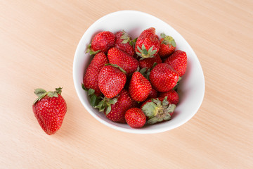 strawberries in a bowl on the table