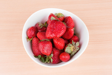 strawberries in a bowl on the table