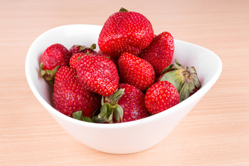 strawberries in a bowl on the table