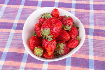 strawberries in a bowl on the table