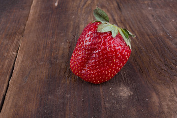one red strawberry on table