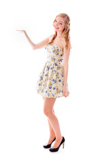 Naklejka premium Beautiful young woman standing with her arm outstretched