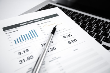 Businessman analyzing investment charts with laptop
