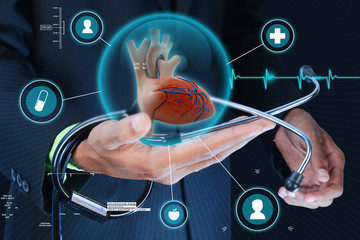 Smart hand showing human heart and stethoscope