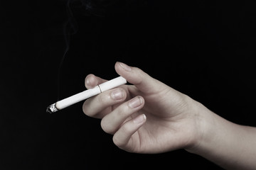 Drug abuse concept - hand holding cigarette