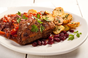 fillet of duck with roasted potatoes, vegetables and cranberry