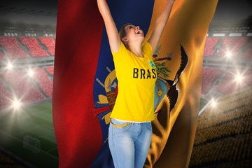 Excited football fan in brasil tshirt holding ecuador flag