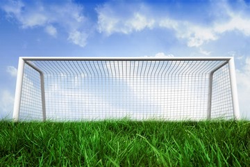 Fototapeta na wymiar Goalpost on grass under blue sky