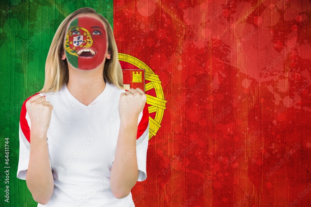 Wall mural Excited portugal fan in face paint cheering