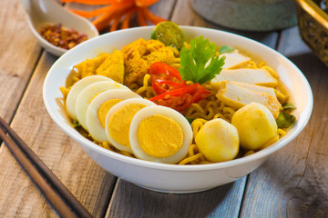 Spicy curry instant noodles. Asian cuisine, ready to serve on wo