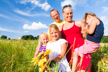 Obraz premium Family in grass in summer