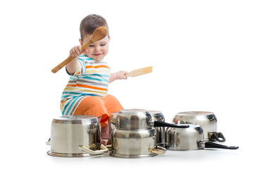 baby boy using wooden spoons to bang pans drumset © Oksana Kuzmina