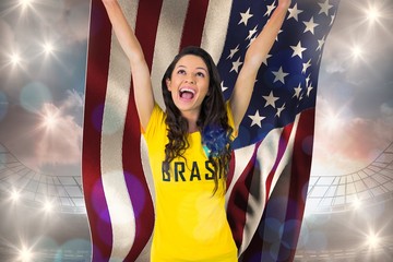 Excited football fan in brasil tshirt holding usa flag