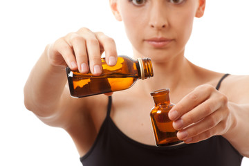 Young woman holding two bottles of medicine