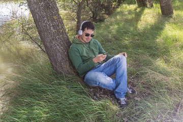 Naklejka na ściany i meble man listening music in the field