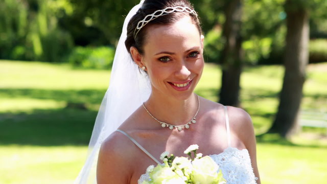 Smiling bride walking towards the camera