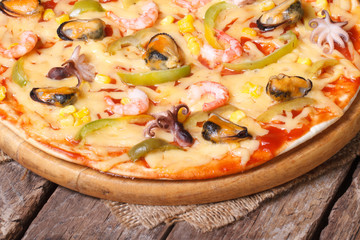 hot pizza with shrimp, mussels and octopus close-up  horizontal