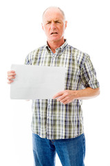 Frustrated senior man holding a blank placard