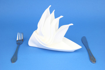 Folded napkin on the blue background