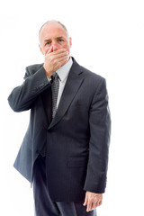 Businessman with hand over his mouth