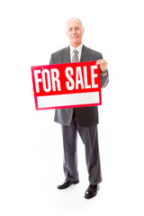 Businessman showing a for sale sign