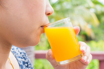 Woman drinking orange juice