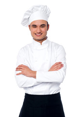 Confident young cook posing in uniform