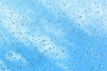 background of beautiful water drops on glass and blue sky